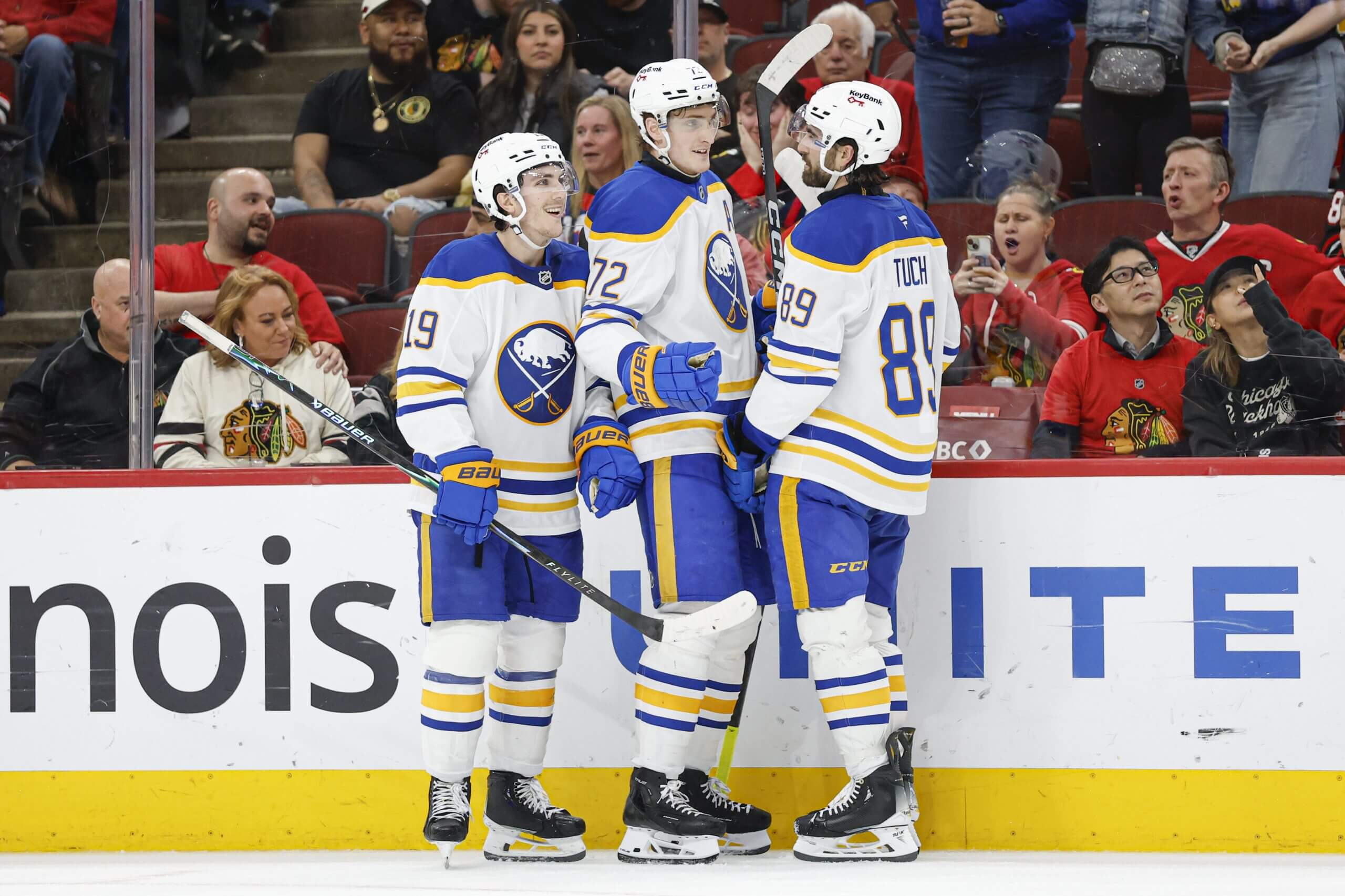Tage Thompson gets congratulated by two teammates after scoring.