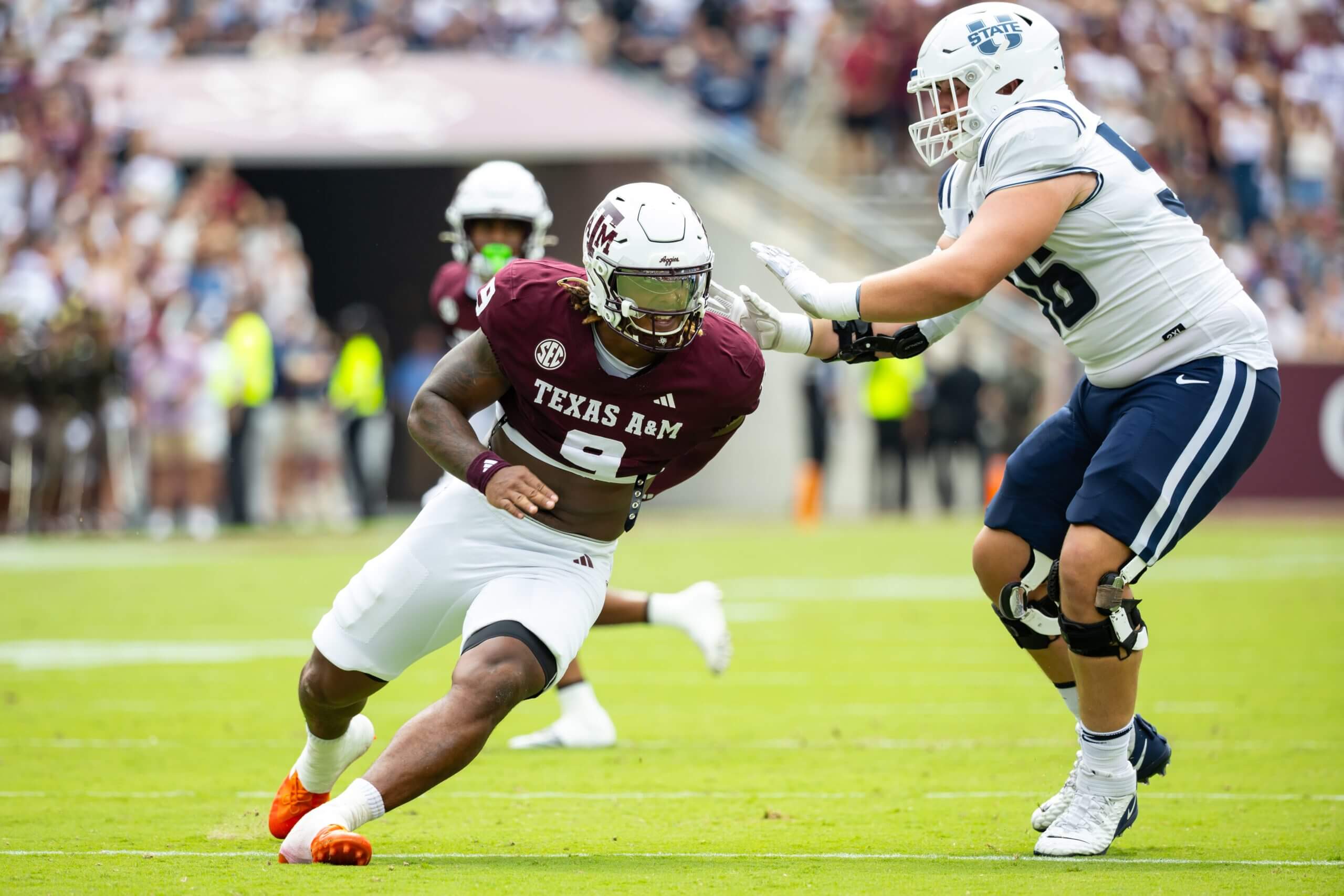 Cashius Howell of Texas A&M works against the block of an opponent.