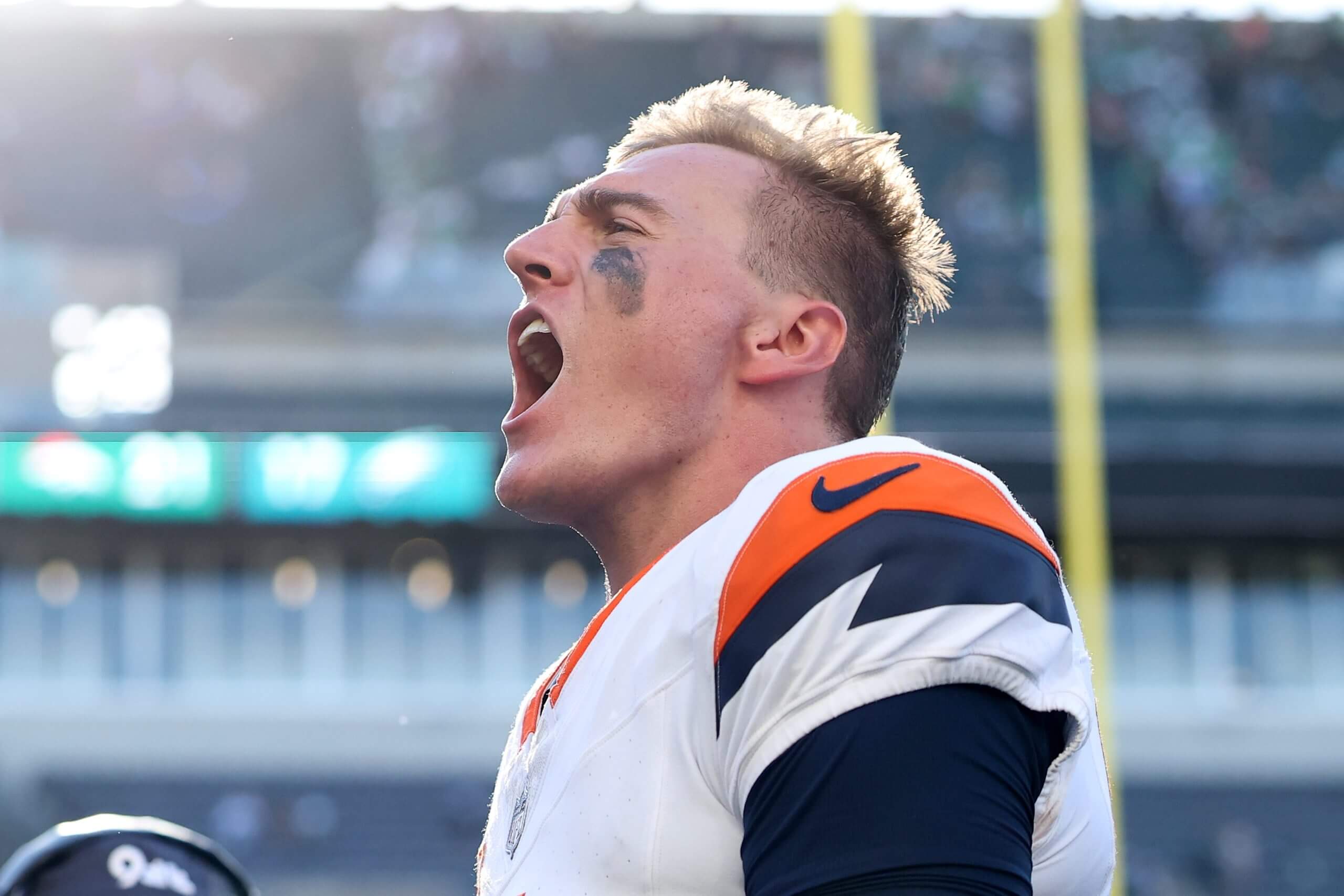 Denver Broncos quarterback Bo Nix, his face smeared with eye black, screams in celebration at the end of his team's win on Sunday.